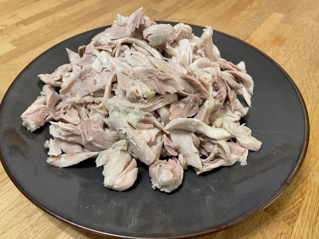 Shredded Chicken on Brown plate on wooden table
