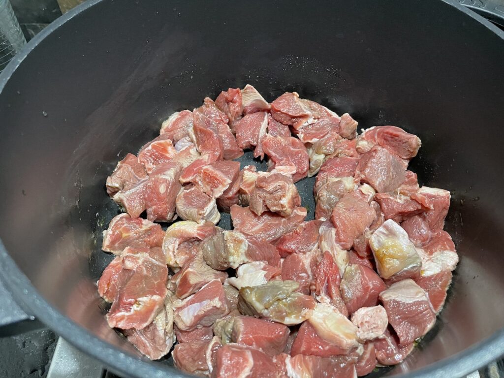 olive oil in a big pan with small beef cubes