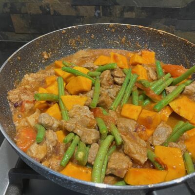 Adding Beans and pumpkin to the pinakbet mixture
