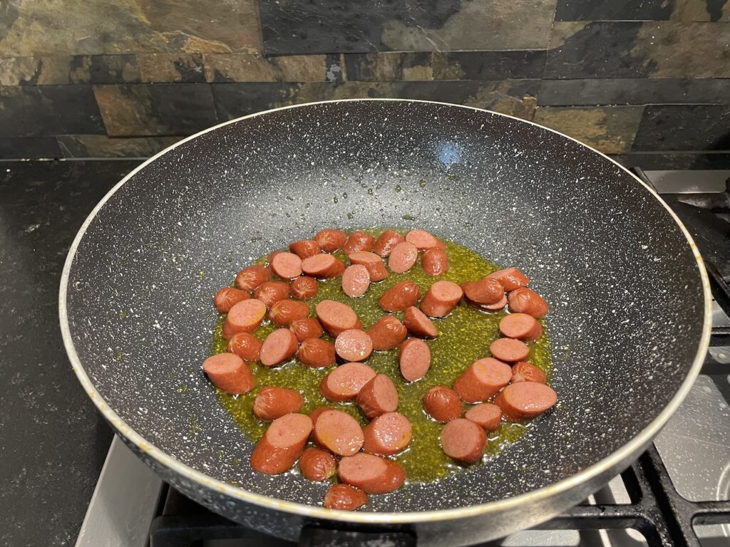 Cook hotdog in oil for Jollibee Spaghetti