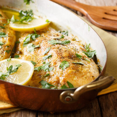 Fish-Fillet-qith-Butter-Lemon-saucelemon-and-parsley-close-up-in-a-copper-pan