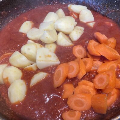 Pork caldereta adding carrots and potatoes