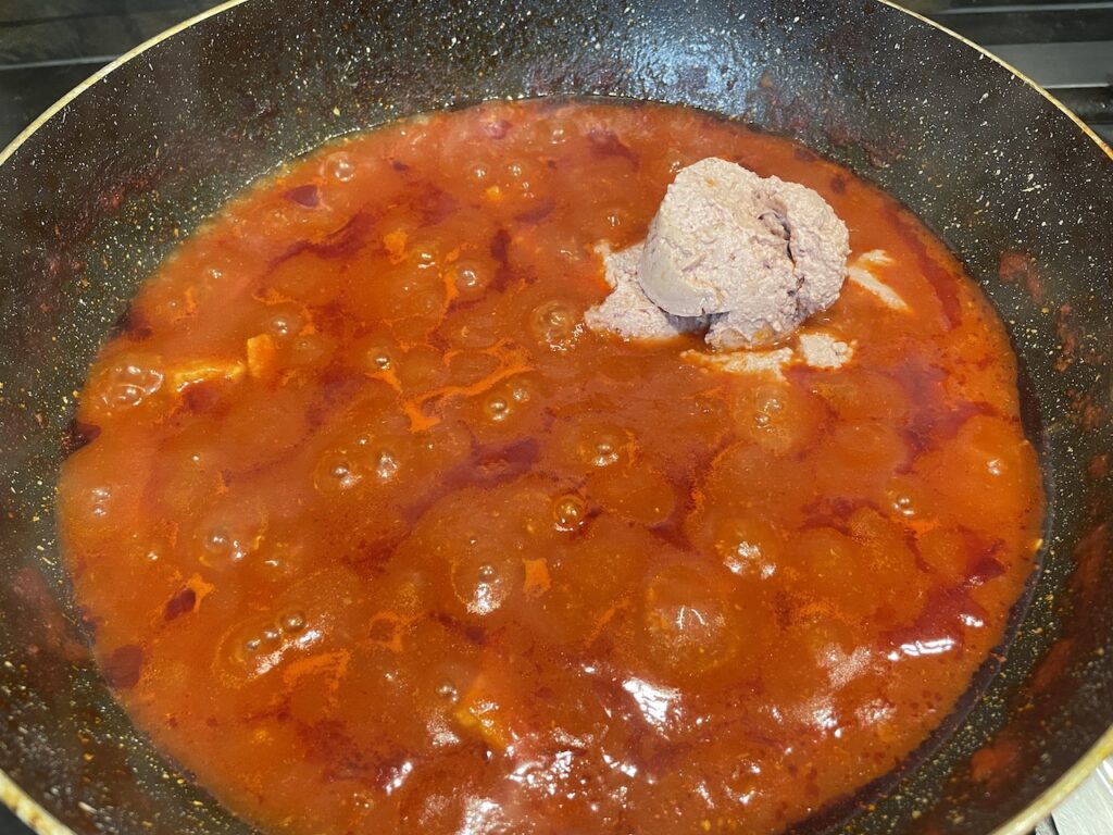 Stirring in liver spread for Pork Caldereta